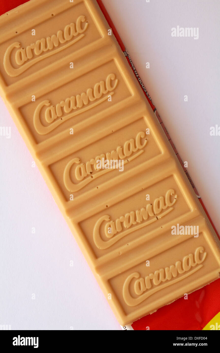 bar of unwrapped Nestle Caramac chocolate set on white background - looking down on from above Stock Photo