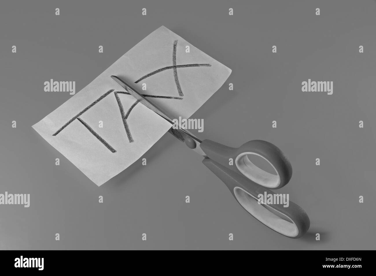 Scissor cutting the word tax hires stock photography and images Alamy