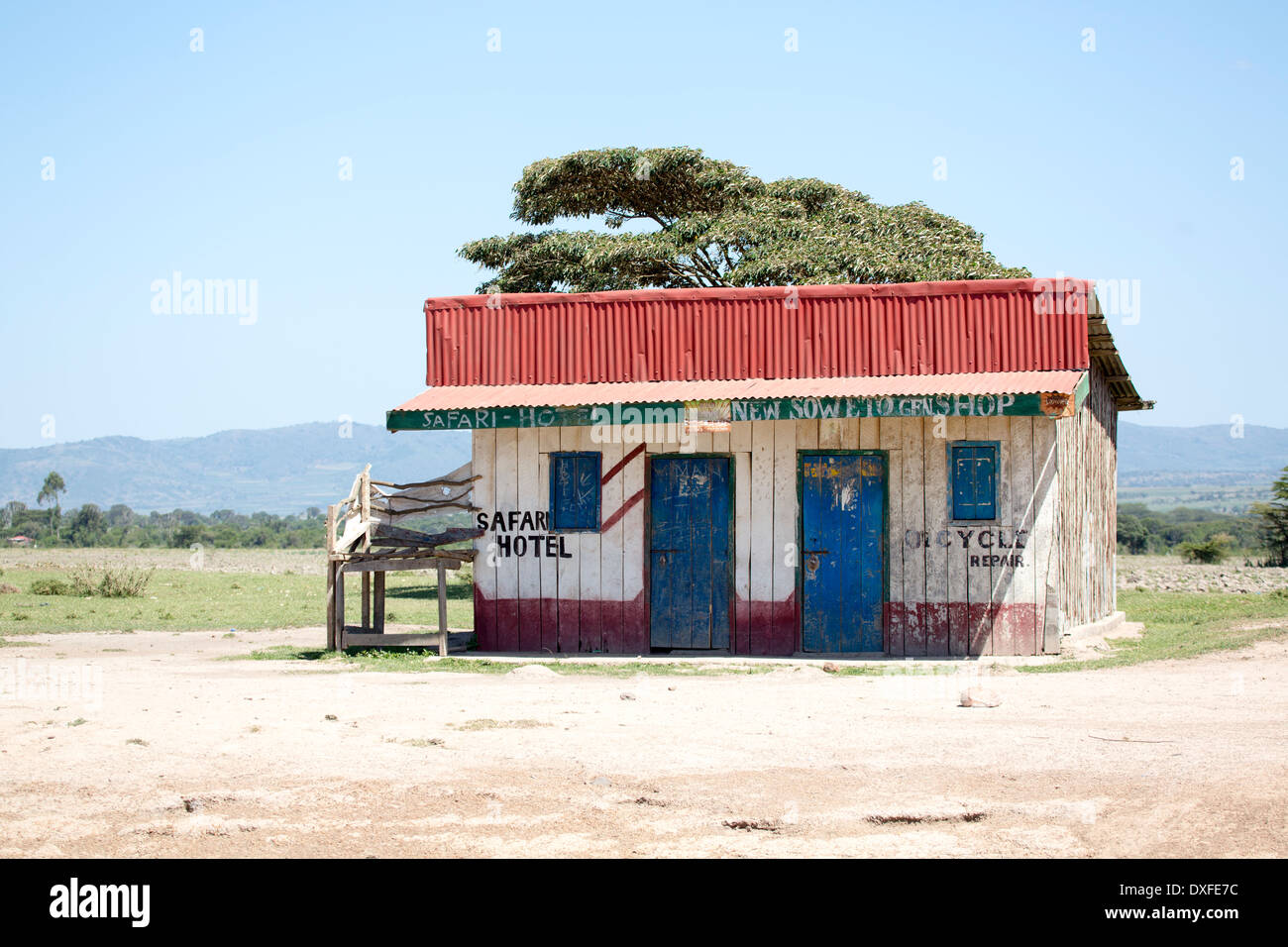 Image of the compact Safari hotel situated in the Masai Mara Kenya next door to the Soweto General store and cycle repair shop Stock Photo