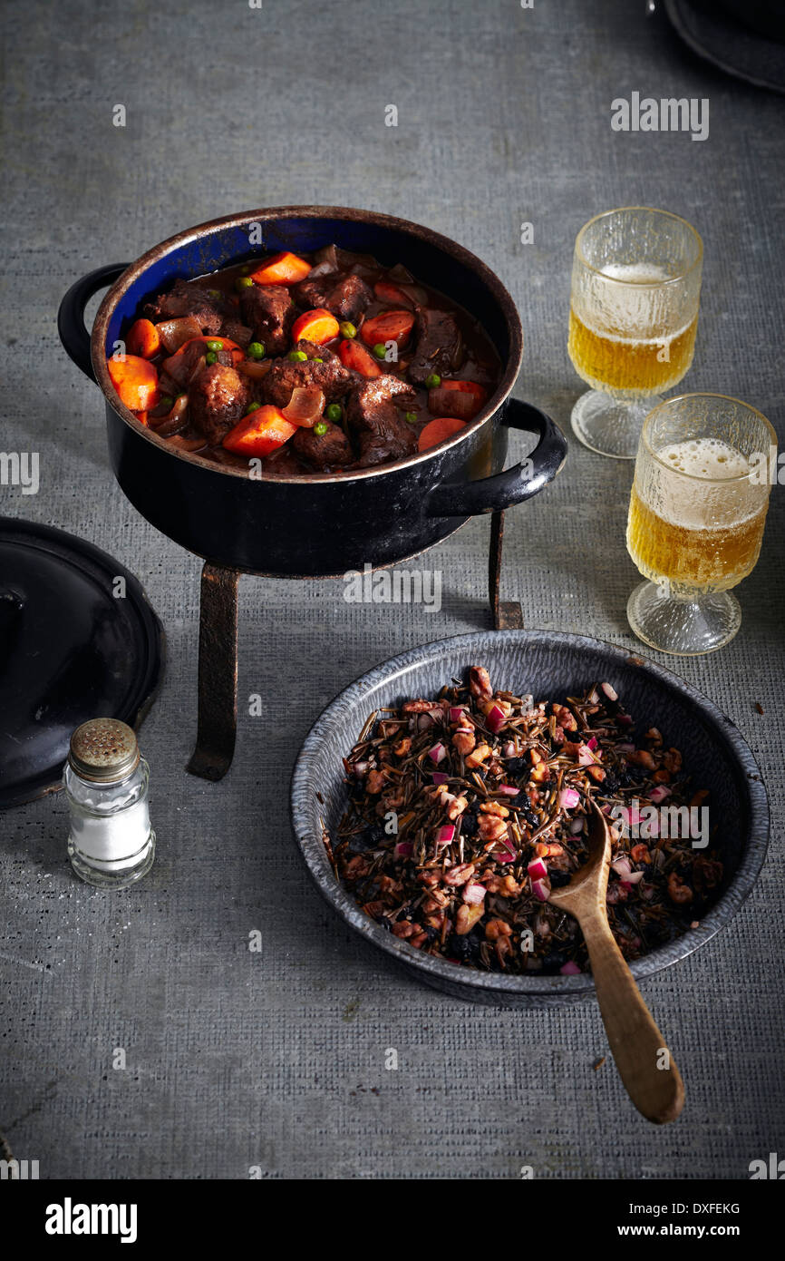 Bison Stew in Cooking Pot and Wild Rice in bowl with Beer, studio shot ...