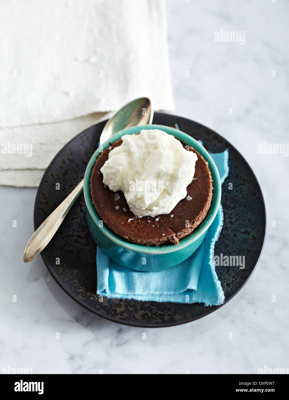 Dark Chocolate Souffles in ramekin on plate with sppon, studio shot