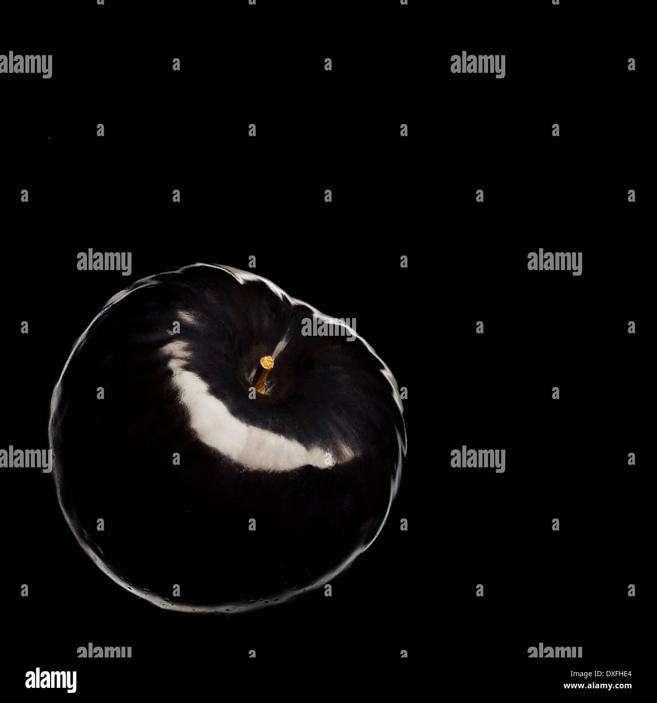 Black plum on black background Stock Photo