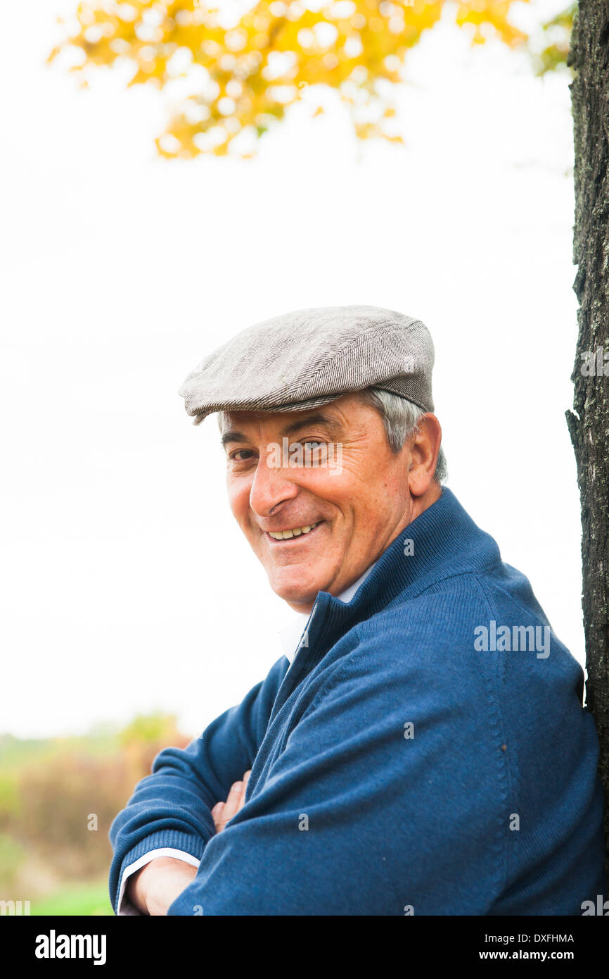Senior Man leaning against Tree, Mannheim, Baden-Wurttemberg, Germany Stock Photo