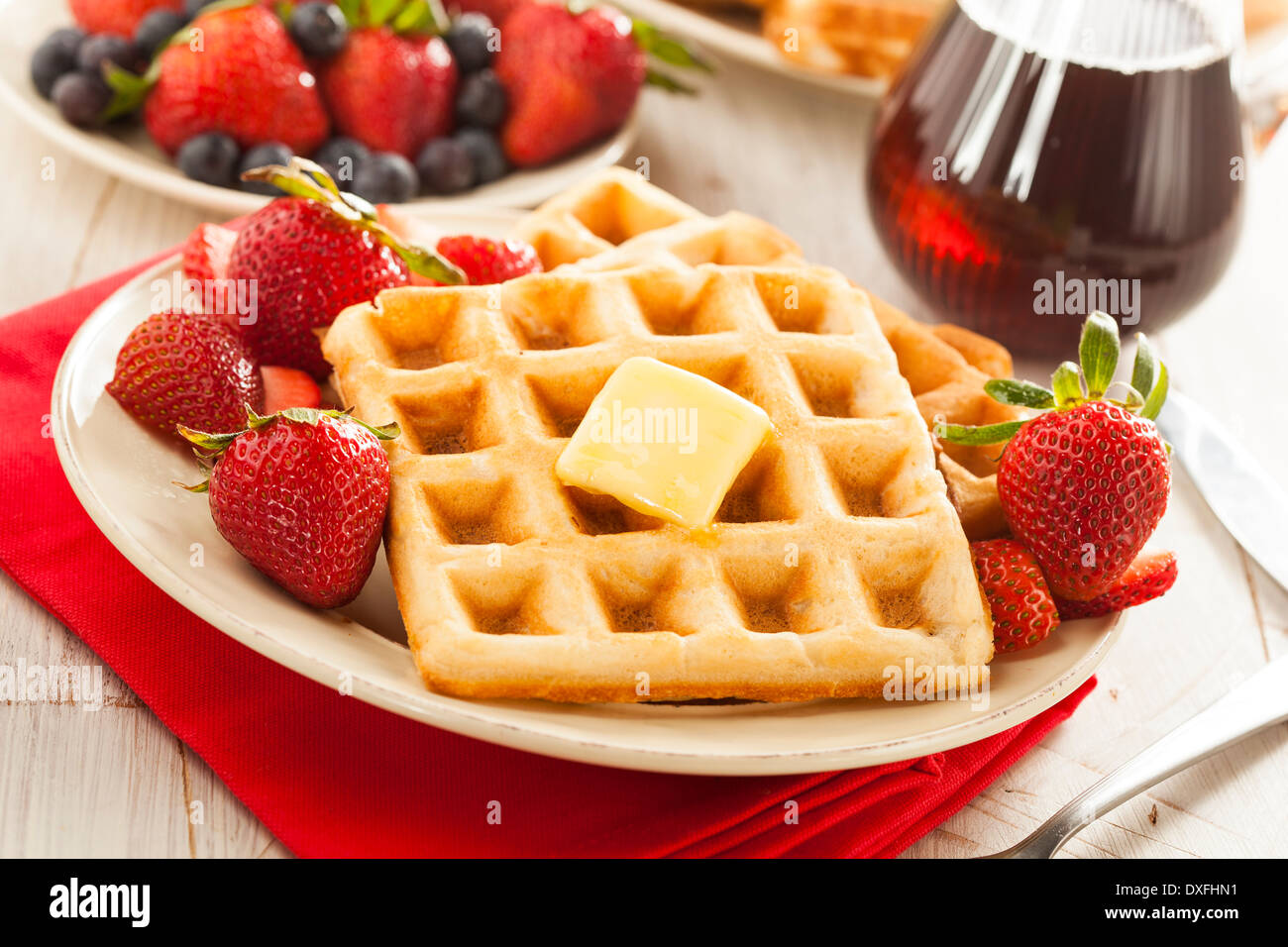 Homemade Belgian Waffles with Strawberries and Maple Syrup Stock Photo
