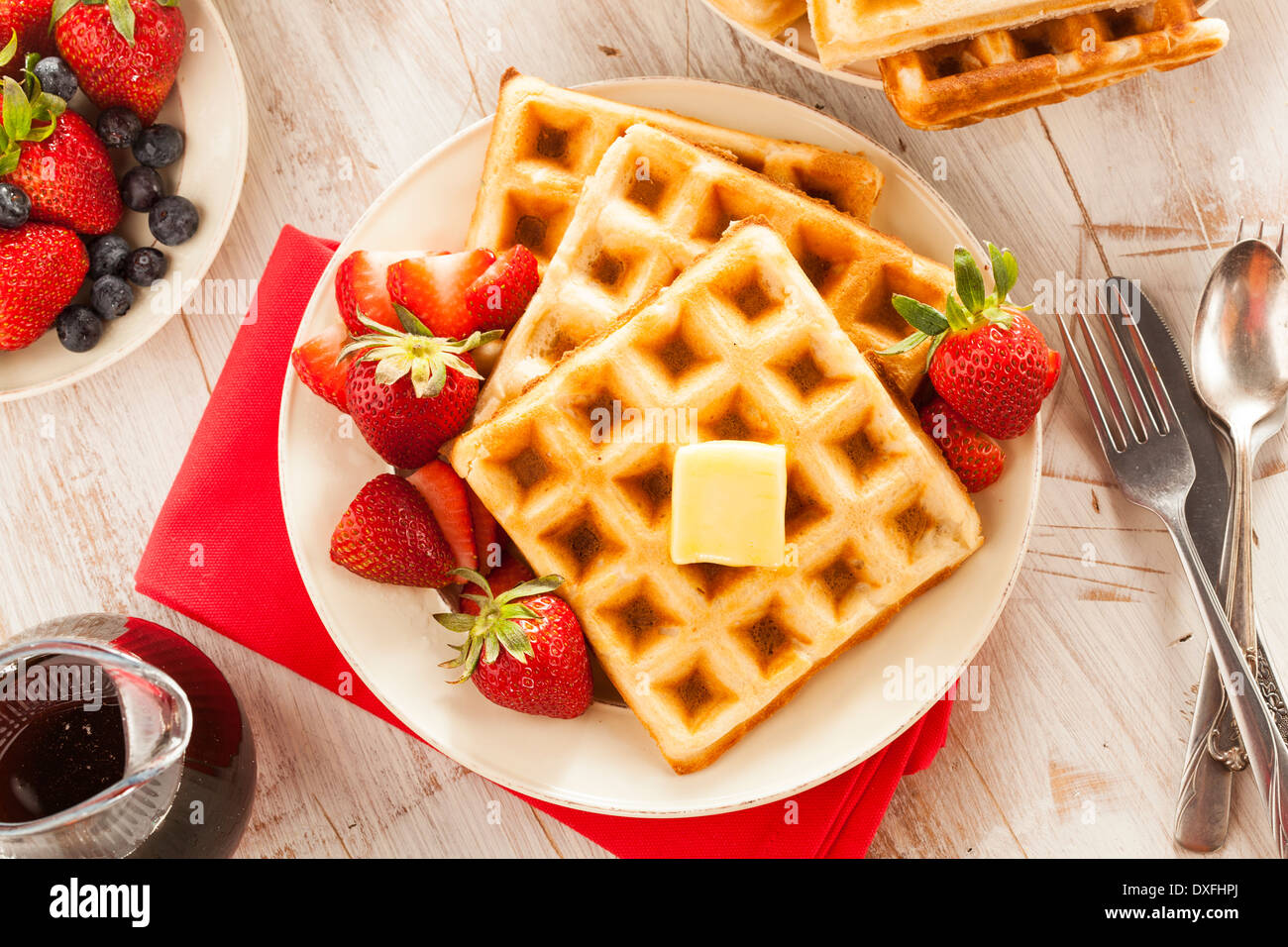 Homemade Belgian Waffles with Strawberries and Maple Syrup Stock Photo