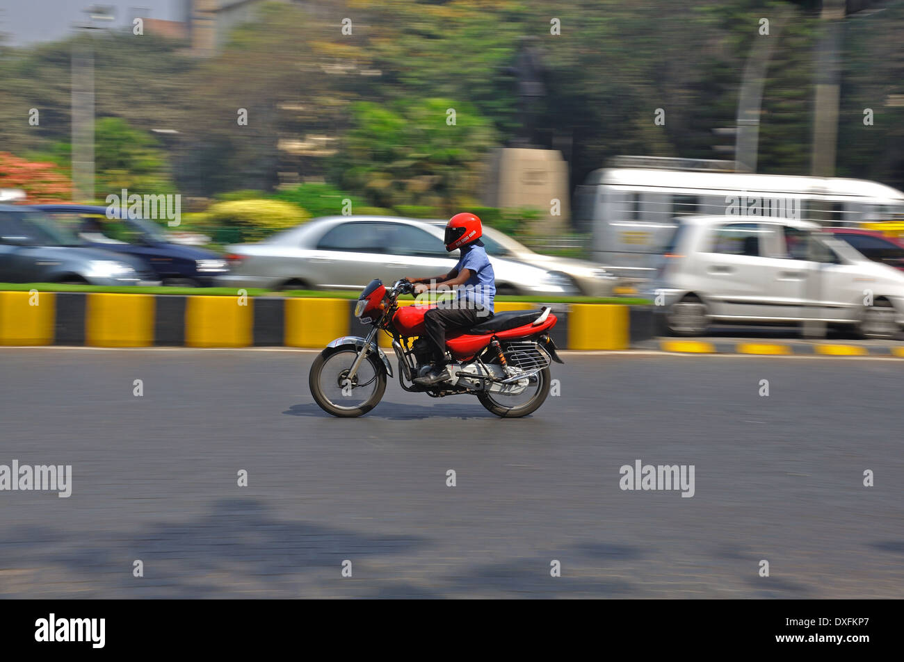 A man rides on a motorbike through the busy traffic in the center of Mumbai. Stock Photo