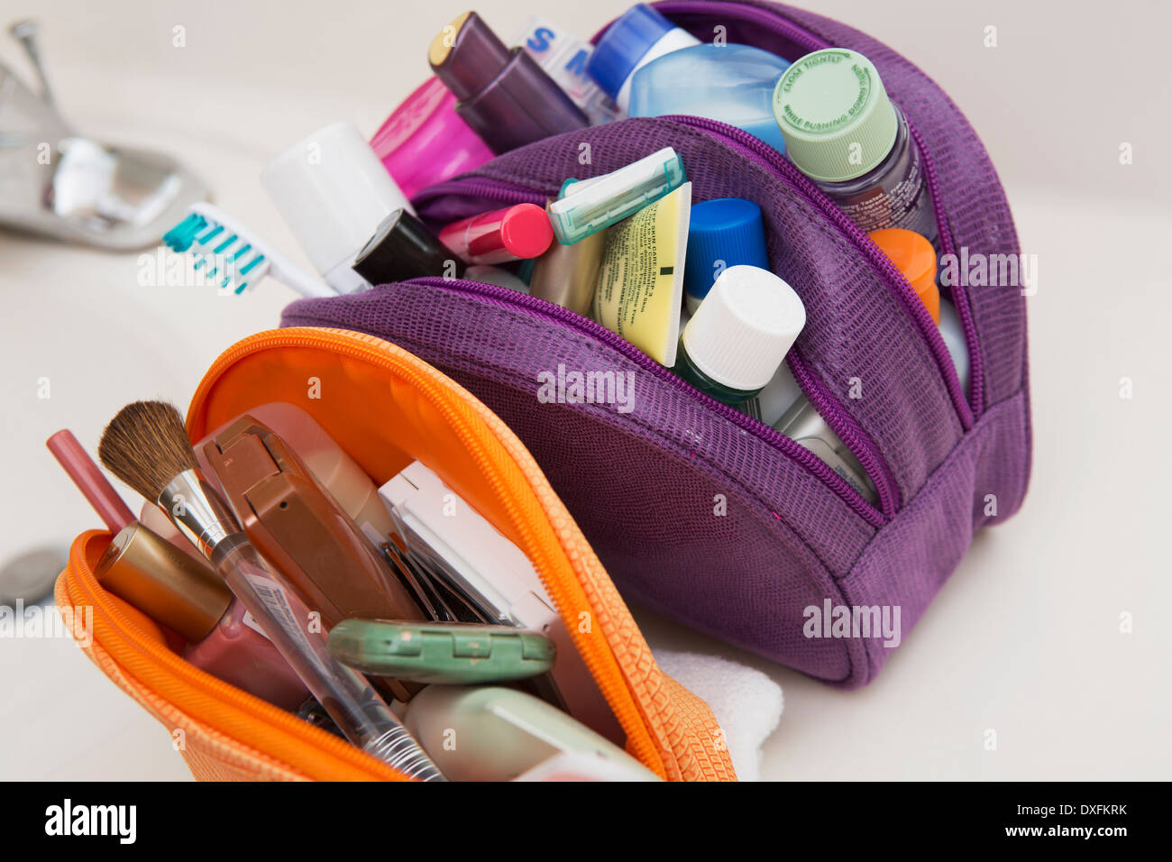 Women's toiletry, cosmetic travel bag on bathroom counter, filled with  toothbrush, lotion, makeup and other beauty products, USA Stock Photo -  Alamy