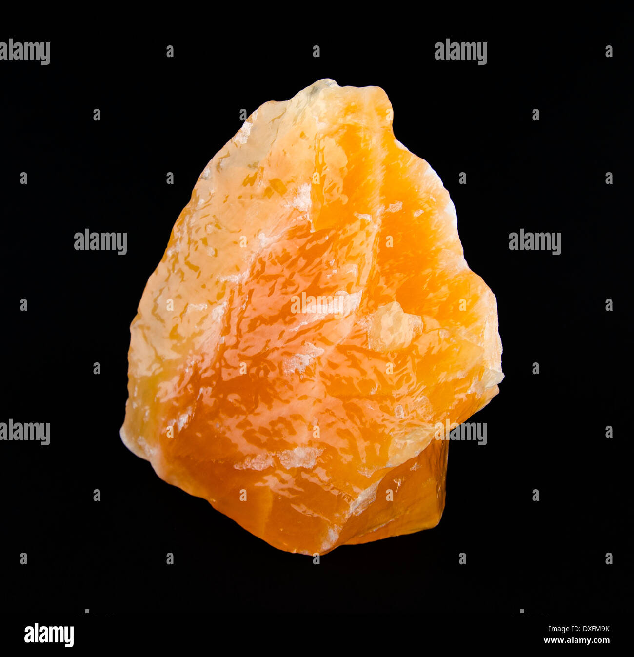 Yellow and orange calcite, found in Mexico on black background - a carbonate mineral and polymorph of calcium carbonate, CaCO3. Stock Photo