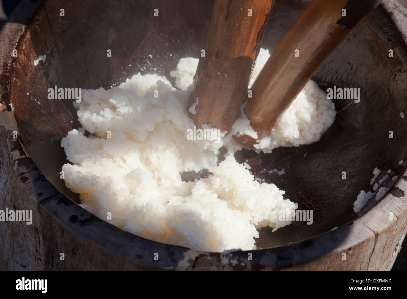 Cooked rice is pounded into Mochi for traditional Japanese New Year's treat. Stock Photo