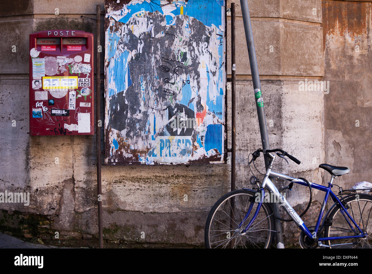 Mailbox fixed on a wall of a Roman house and bycicle locked on a sign post. Stock Photo