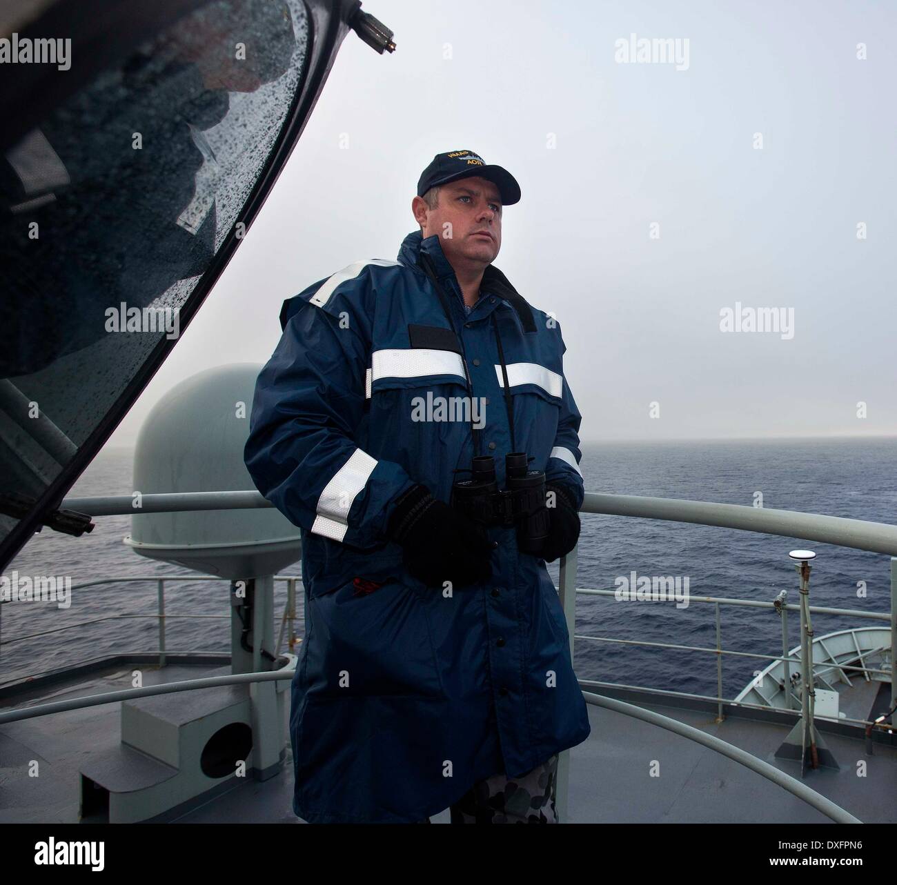 Canberra. 23rd Mar, 2014. Photo released by Australian Maritime Safety Authority on March 26, 2014 shows an Australian marine staff conducts search operations for the missing Malaysia Airlines flight MH370 on March 23, 2014. © Australian Defense Department/Xinhua/Alamy Live News Stock Photo