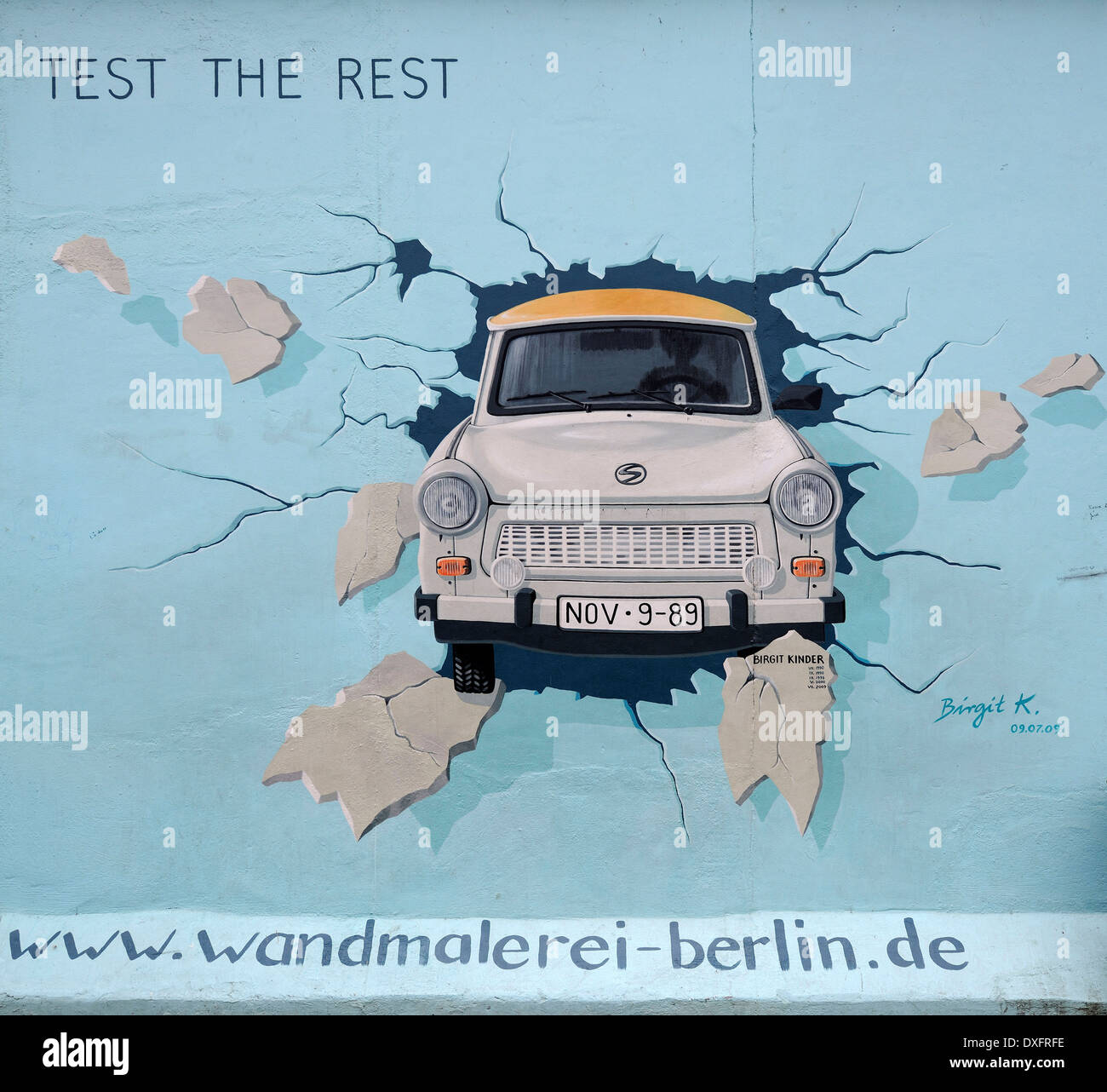 Test the Rest Trabant breaking through the Berlin Wall by Birgit Kinder painting on the Berlin Wall East Side Gallery Berlin Stock Photo