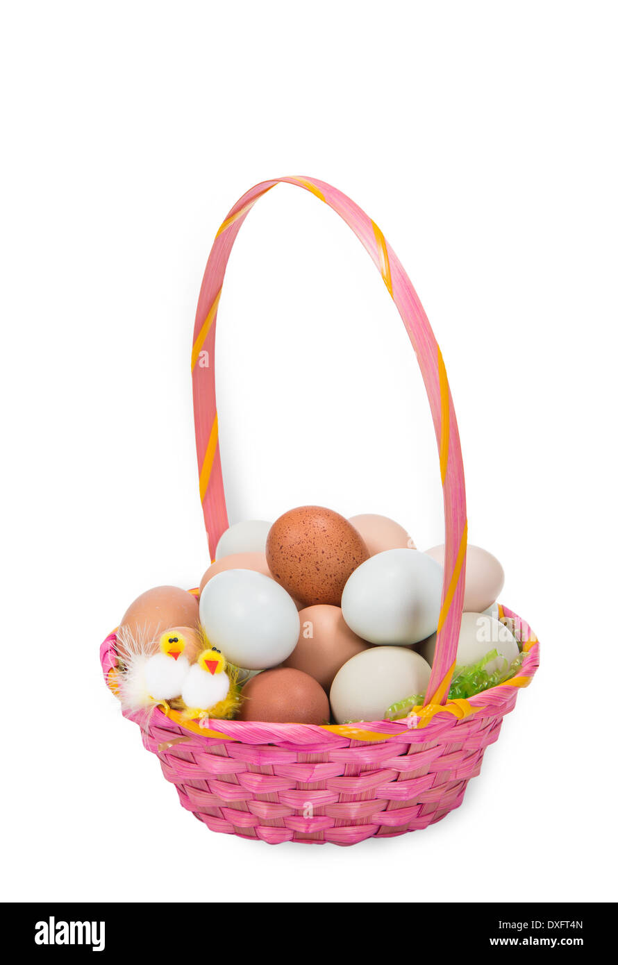 Pink Easter basket filled with colorful eggs and two decorative chickens, isolated on white Stock Photo