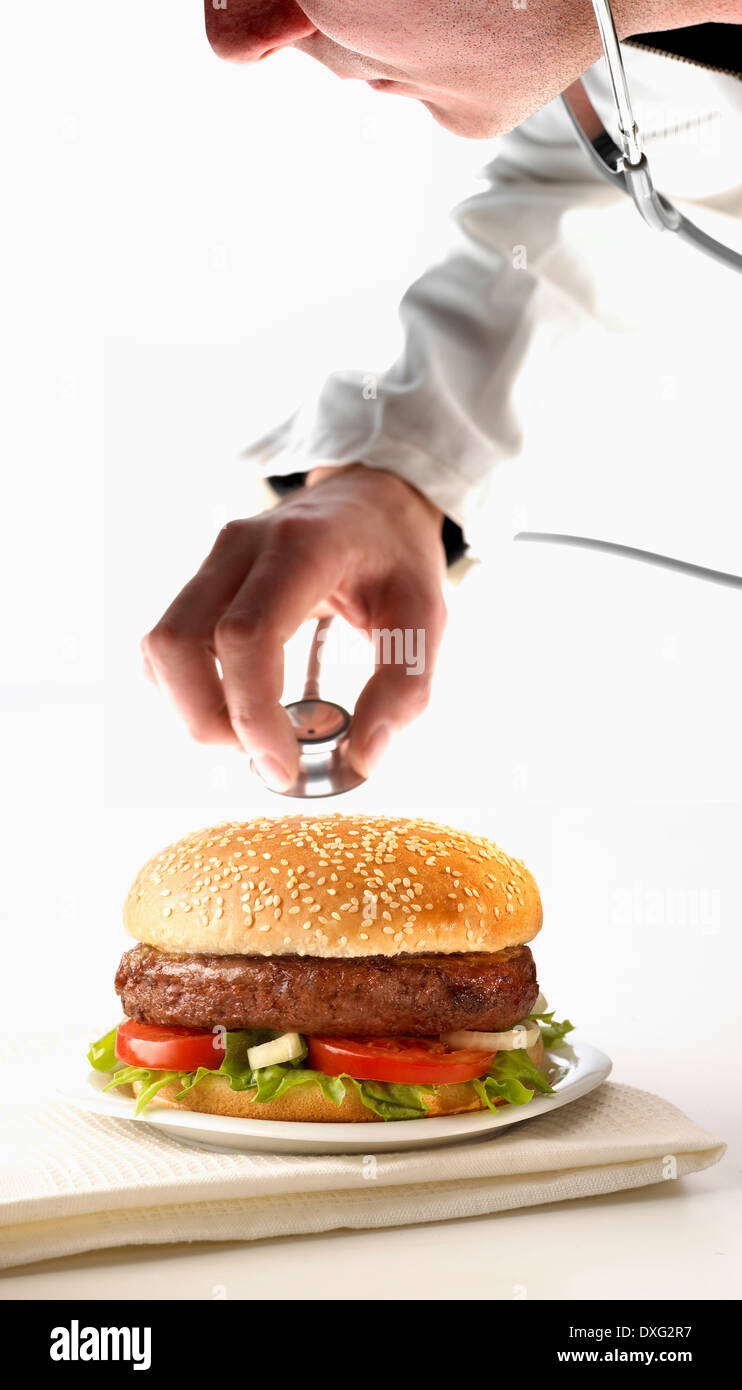 Doctor Examining Burger With Stethoscope Stock Photo