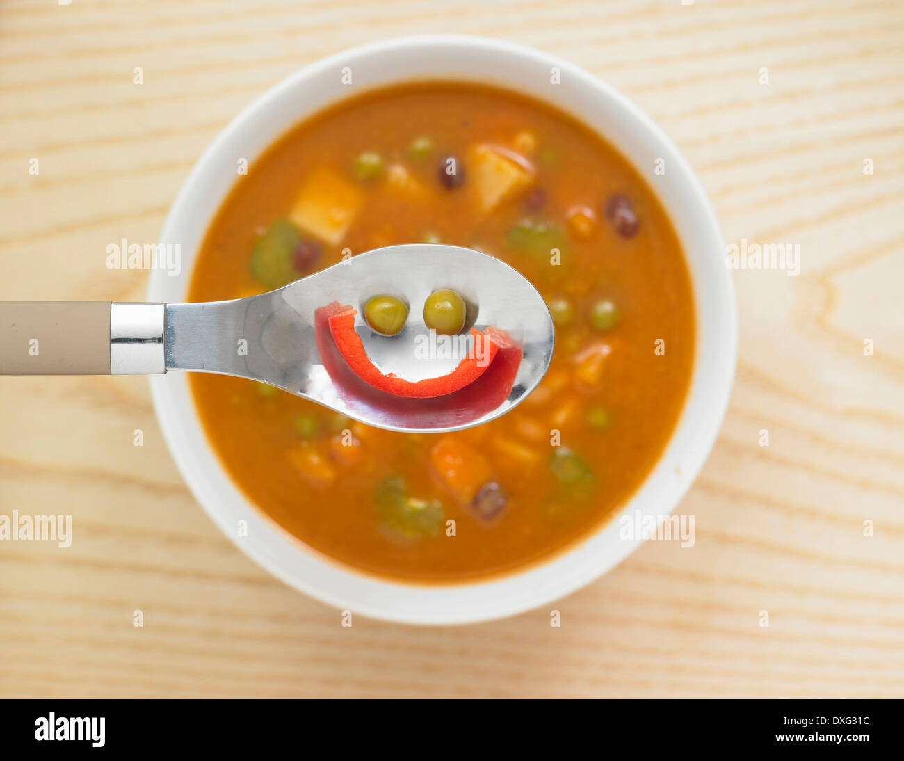 Smiling Face In Spoon Of Vegetable Soup Stock Photo