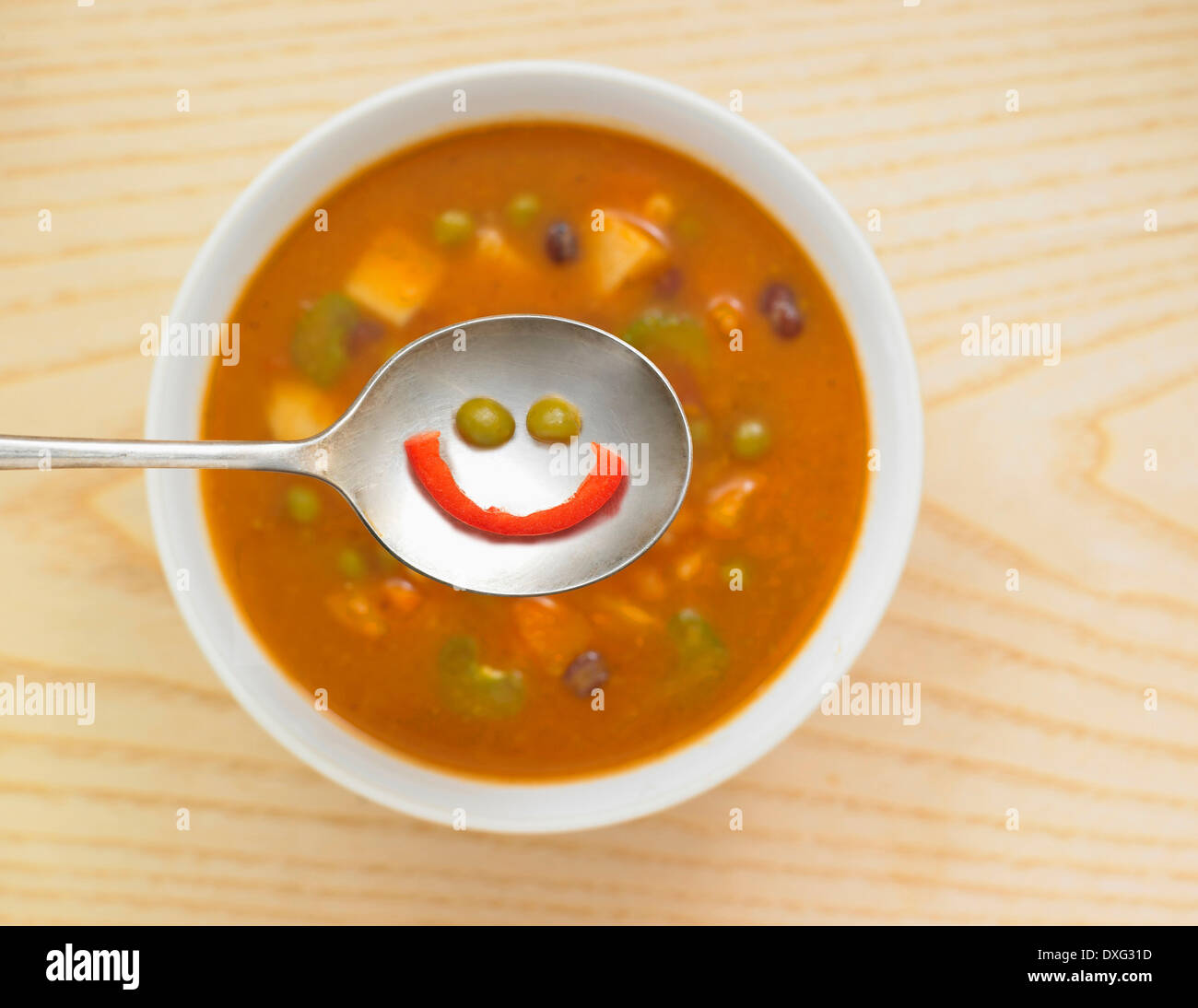 Smiling Face In Spoon Of Vegetable Soup Stock Photo