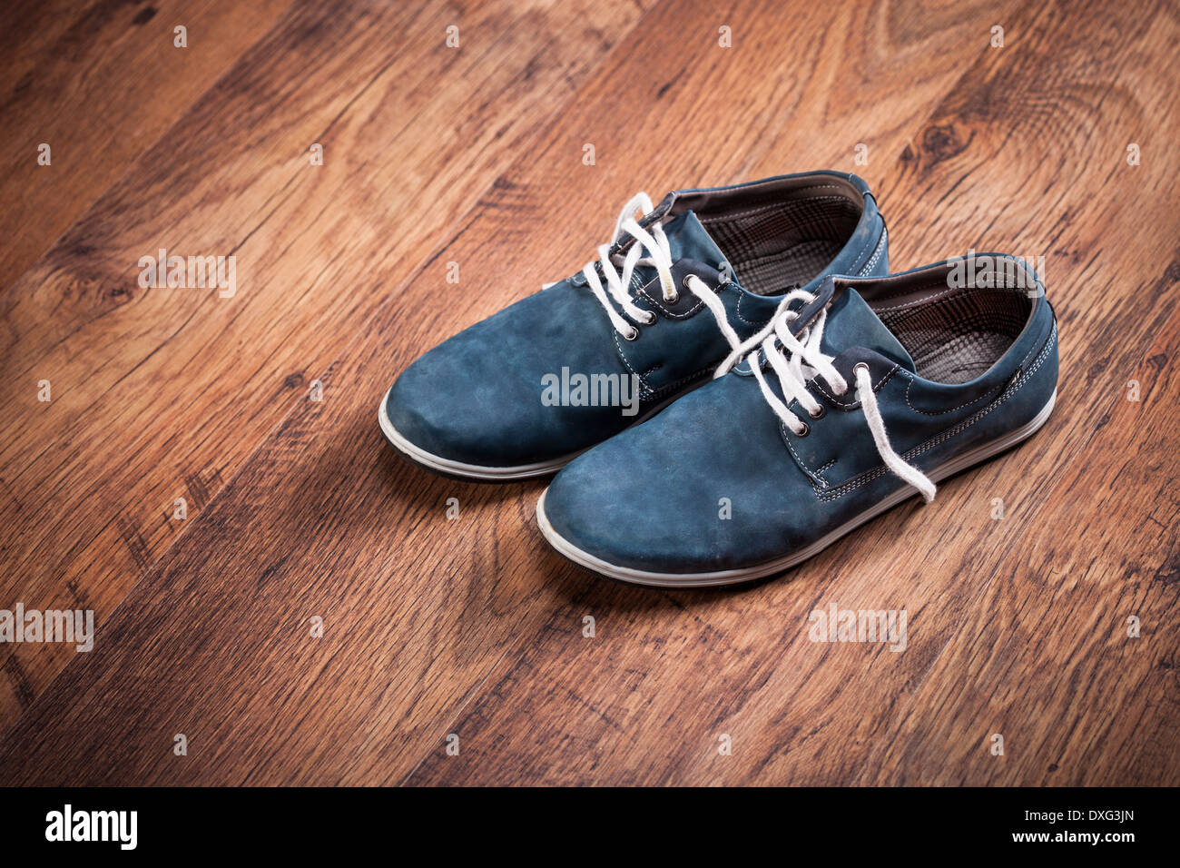 Pair of snickers on wooden floor Stock Photo