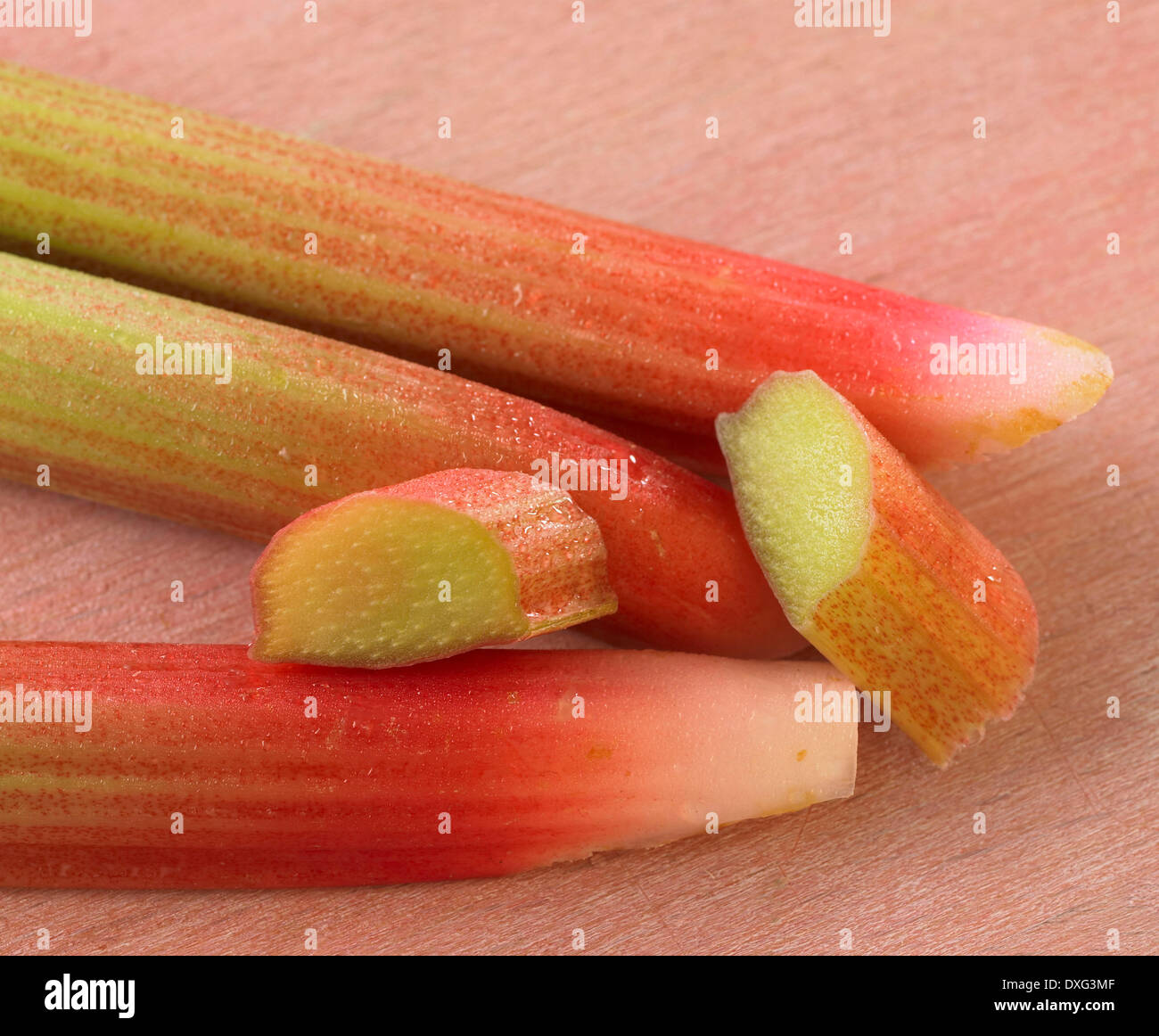 Sliced Stalks Of Rhubarb On Wooden Surface Stock Photo
