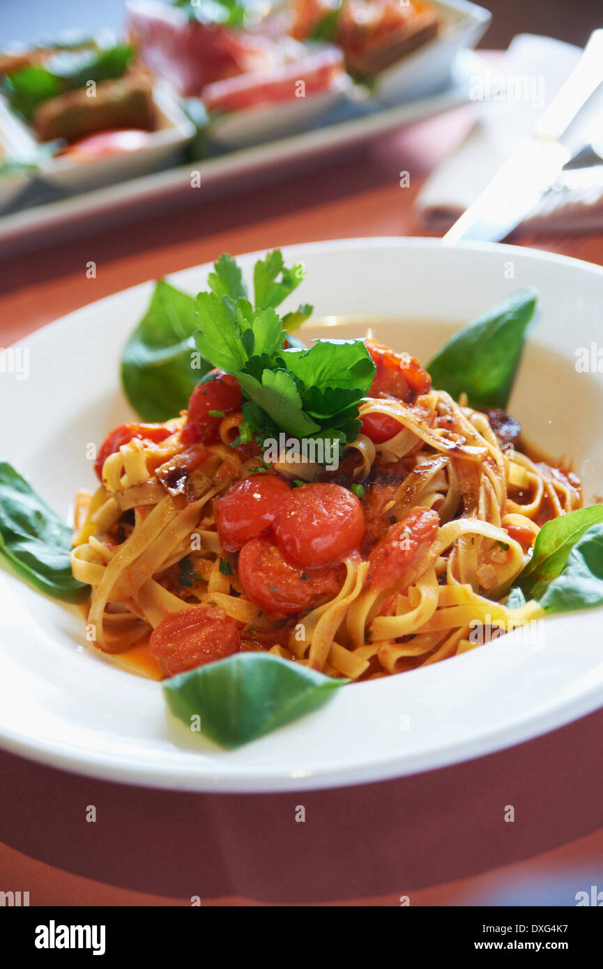 Plate Of Tagliatelli With Tomato and Herbs Stock Photo