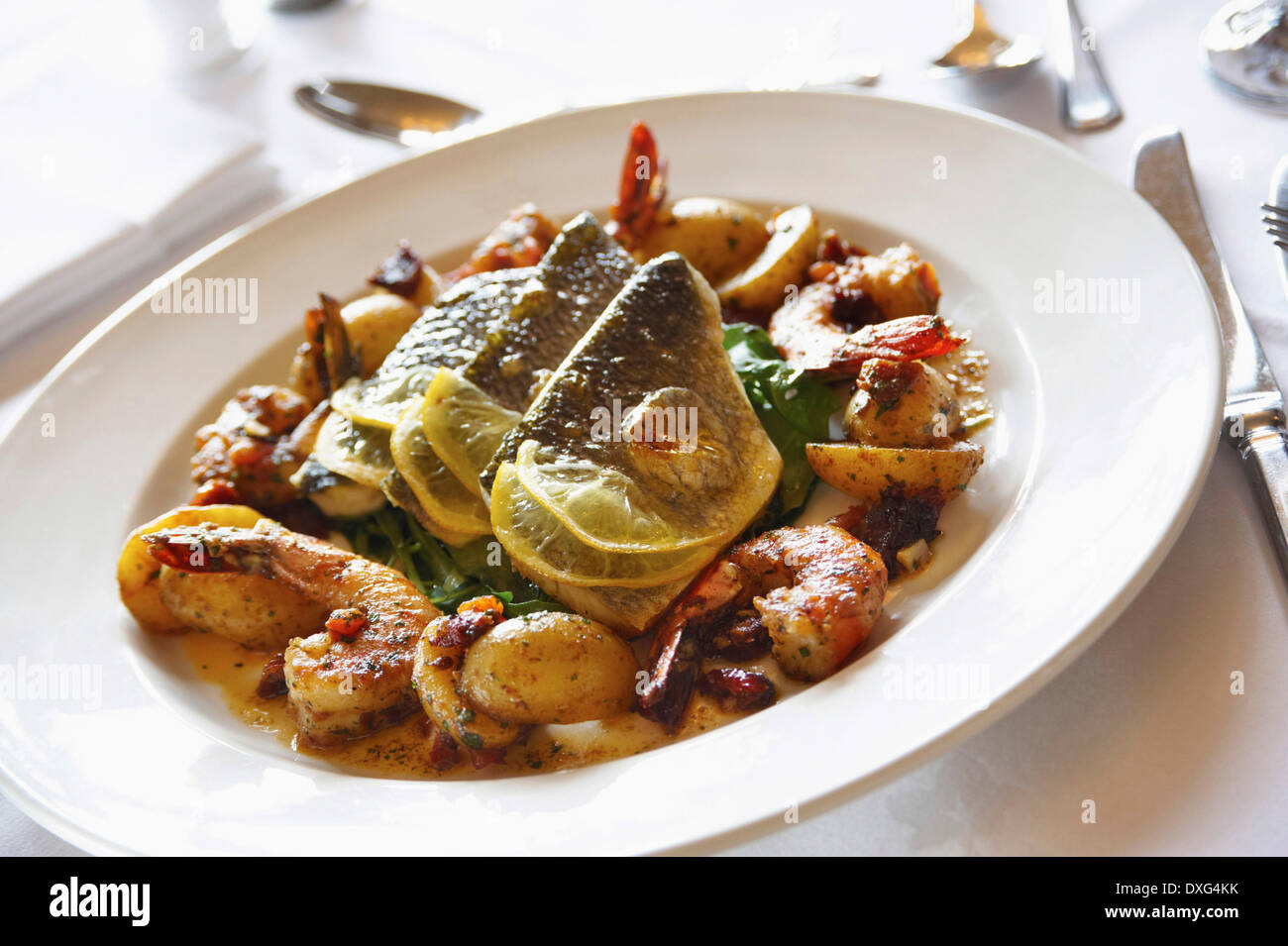 Plate Of Roasted Sea Bass Served With Vegetables Stock Photo