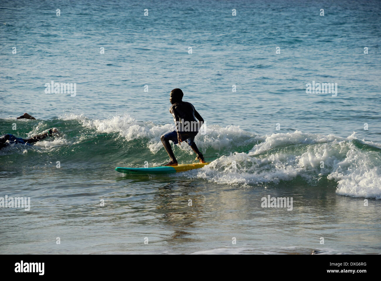 Young black Mozambican boy surfing at Tofo, Mozambique Stock Photo