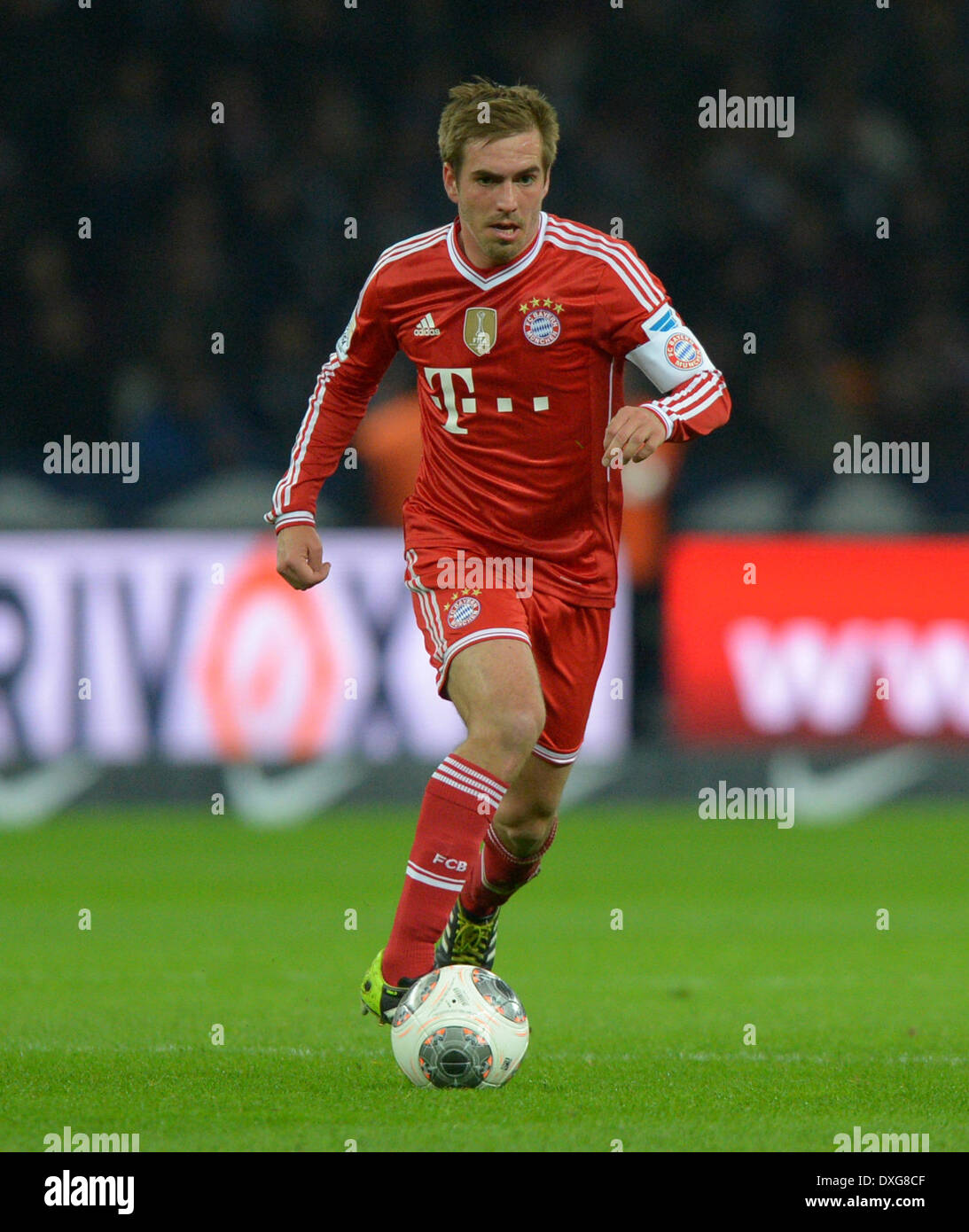 Berlin, Germany. 25th Mar, 2014. Bayern Munich's Philipp Lahm controls the ball during the Bundesliga soccer match between Hertha BSC and FC Bayern Munich in Berlin, Germany, 25 March 2014. Photo: Thomas Eisenhuth/dpa/Alamy Live News Stock Photo