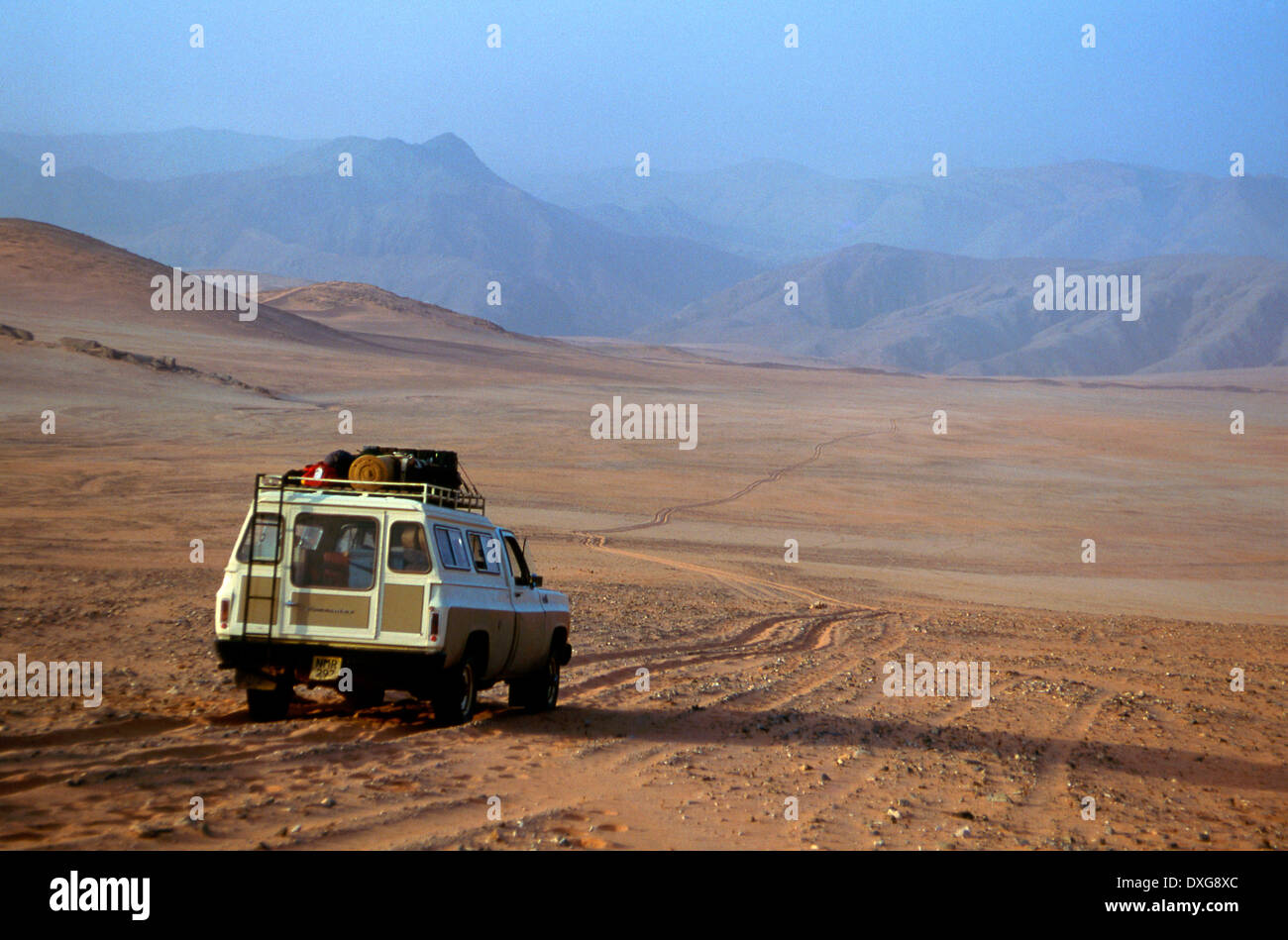 Vehicle on track through the Hartmann valley, Kaokoland, Namibia, descending towards the Cunene