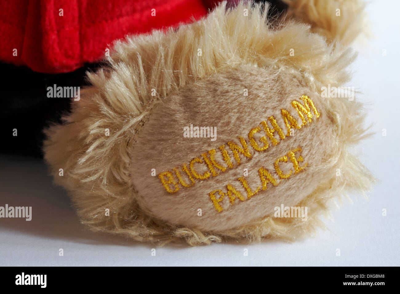 Buckingham Palace merchandise - stitching on paw of Buckingham Palace beefeater soldier guard Teddy bear Stock Photo