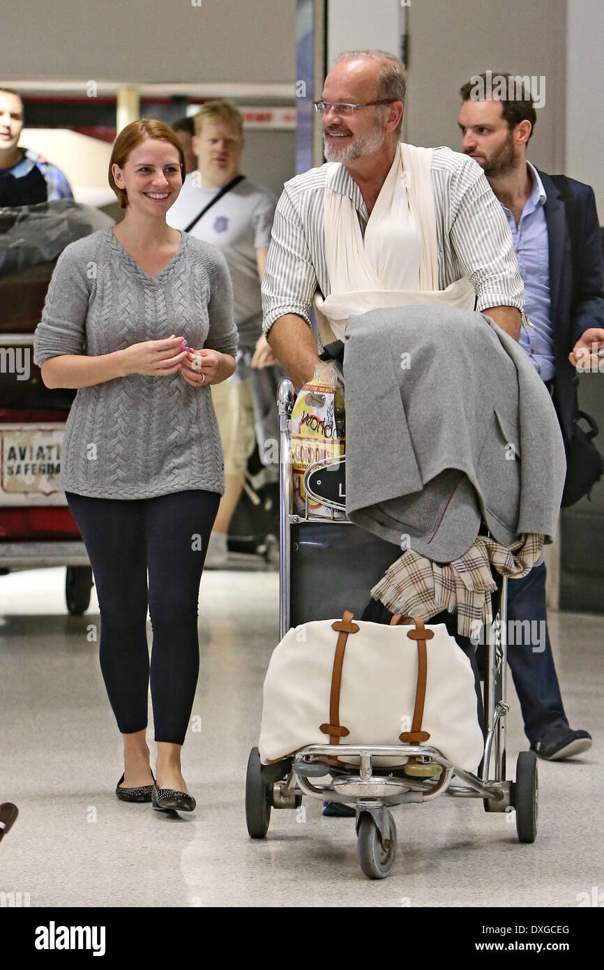 Kelsey Grammer, his wife Kayte Walsh and their baby daughter Faith spotted  at Starbucks at LAX airport after an arriving flight from London. Kelsey  uses a baby sling to carry Faith. Los, image size:866x1390