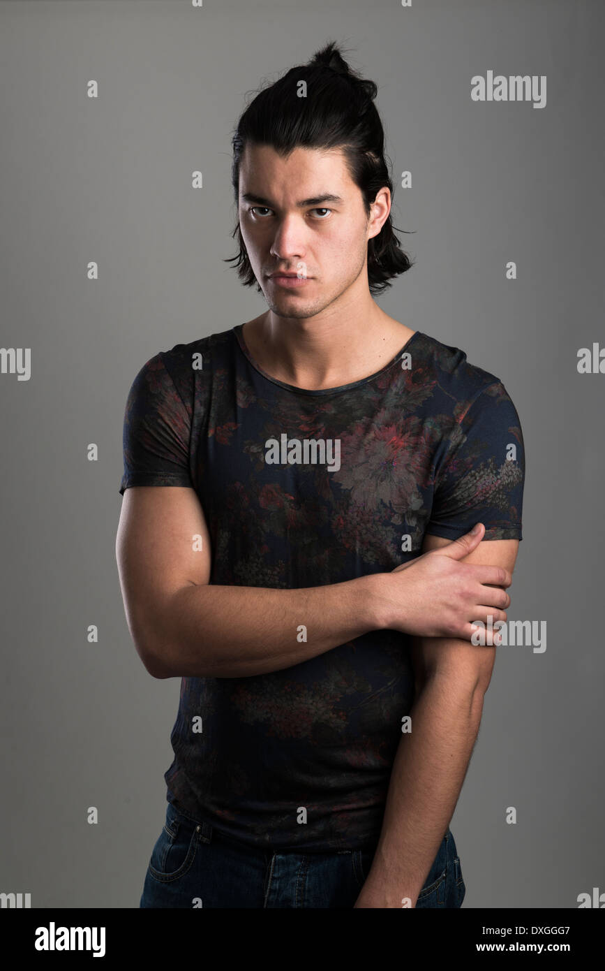 Portrait of handsome Malaysian man wearing flowery top Stock Photo