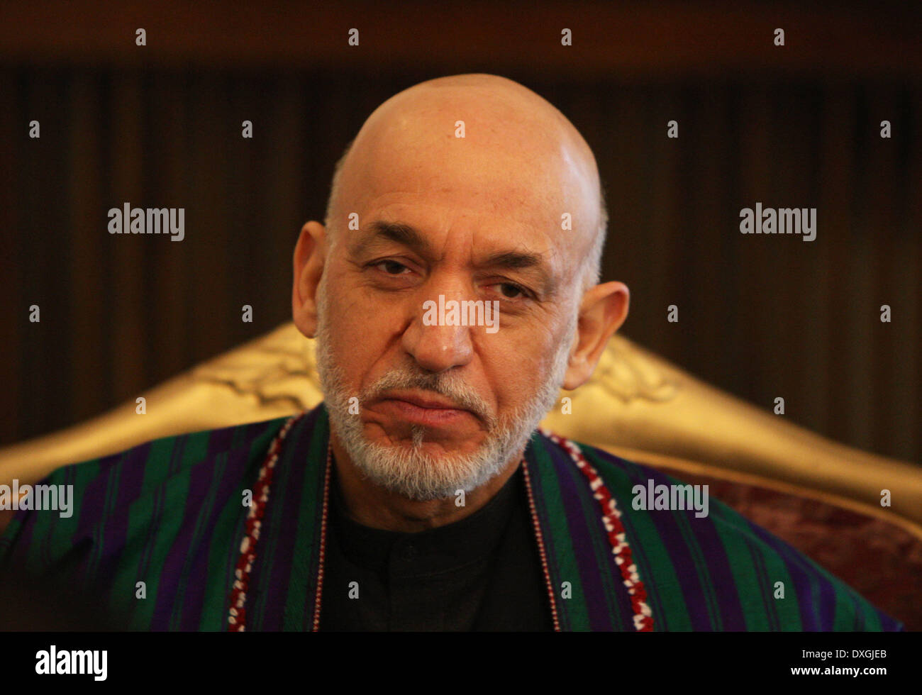 Kabul, Afghanistan. 26th Mar, 2014. Afghan President Hamid Karzai listens during an interview with Xinhua News Agency at the presidential palace in Kabul, Afghanistan on March 26, 2014. Afghan President Hamid Karzai on Wednesday utterly rejected the rumors and reports suggesting he would sign the controversial Bilateral Security Agreement (BSA) with Washington before April 5 presidential elections to allow limited number of U.S. forces remain in Afghanistan after 2014 pullout of NATO-led troops from the militancy-plagued country. © Ahmad Massoud/Xinhua/Alamy Live News Stock Photo