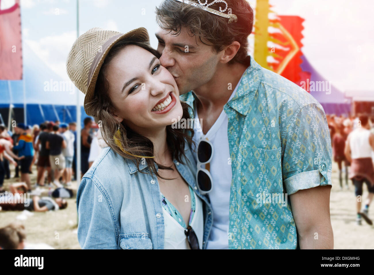 Couple kissing at music festival Stock Photo