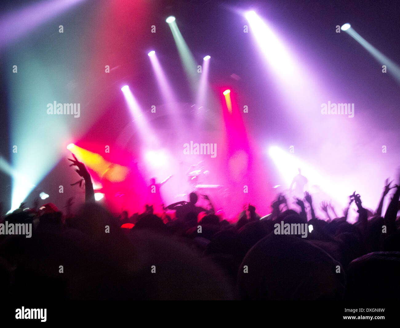 Fans cheering for performers on stage at music festival Stock Photo