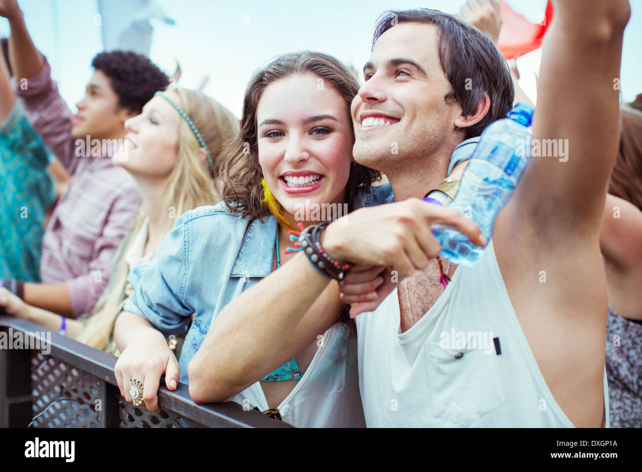 Couple cheering at music festival Stock Photo