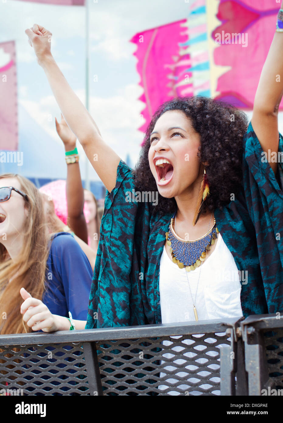 Woman cheering at music festival Stock Photo