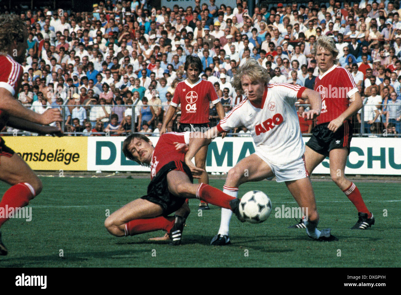 football, Bundesliga, 1983/1984, Ulrich Haberland Stadium, Bayer 04 Leverkusen versus 1. FC Nuremberg 3:0, scene of the match, f.l.t.r. Juergen Gelsdorf (Bayer), Helmut Winklhofer (Bayer), Manfred Burgsmueller (FCN), Wolfgang Voege (Bayer) Stock Photo