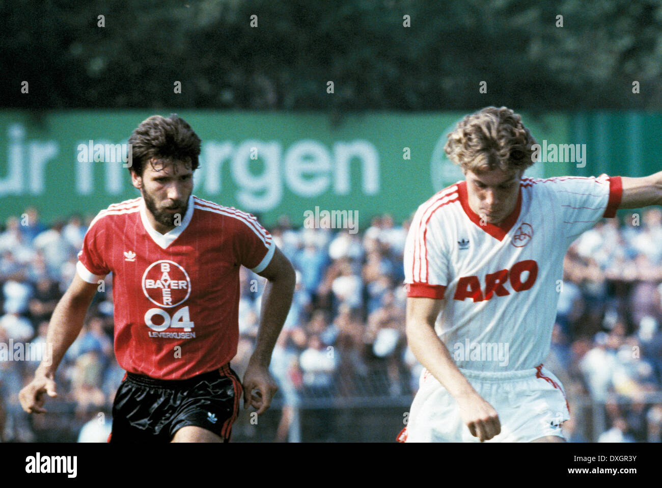football, Bundesliga, 1983/1984, Ulrich Haberland Stadium, Bayer 04 Leverkusen versus 1. FC Nuremberg 3:0, scene of the match, Thomas Hoerster (Bayer) left and Roland Grahammer (FCN) Stock Photo