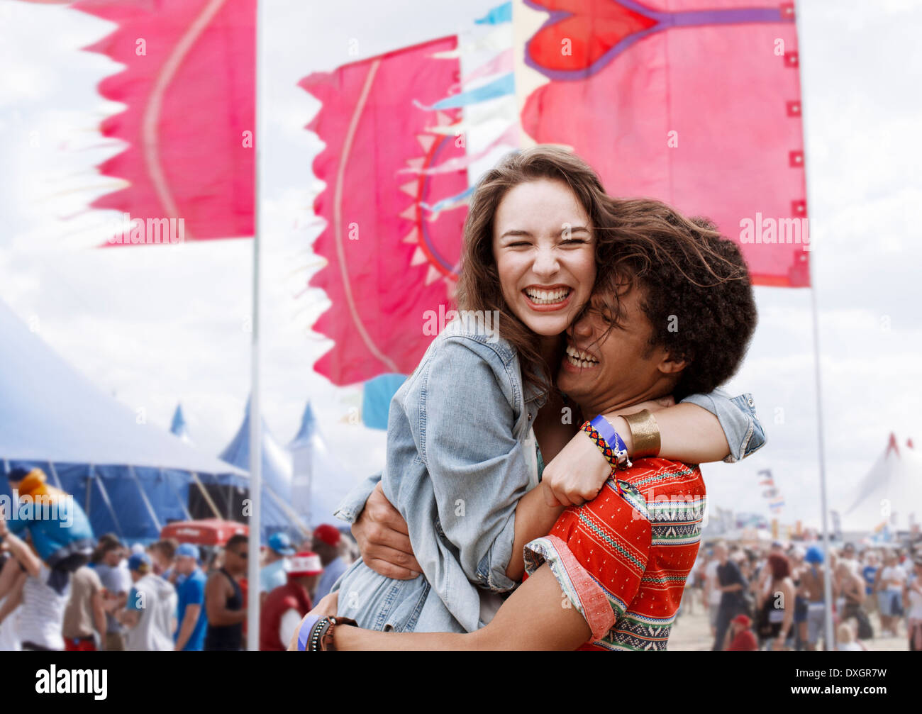 Enthusiastic couple hugging at music festival Stock Photo
