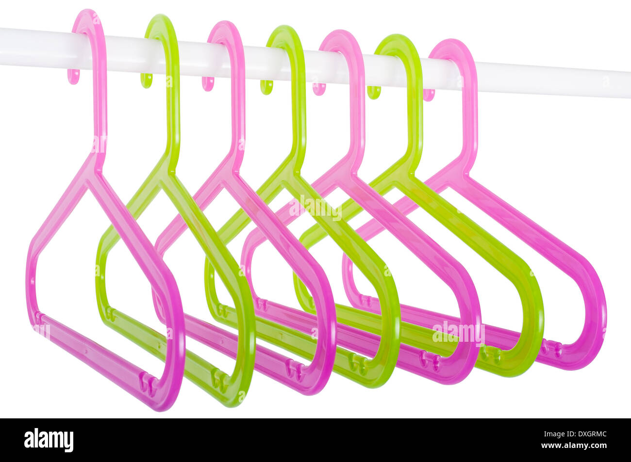 Colored plastic hangers hanging on a rod isolated on white background Stock Photo