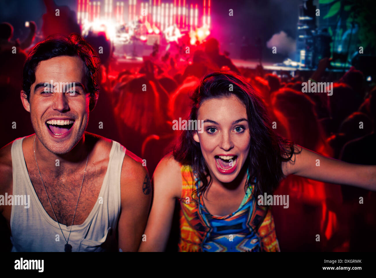 Enthusiastic couple cheering at music festival Stock Photo