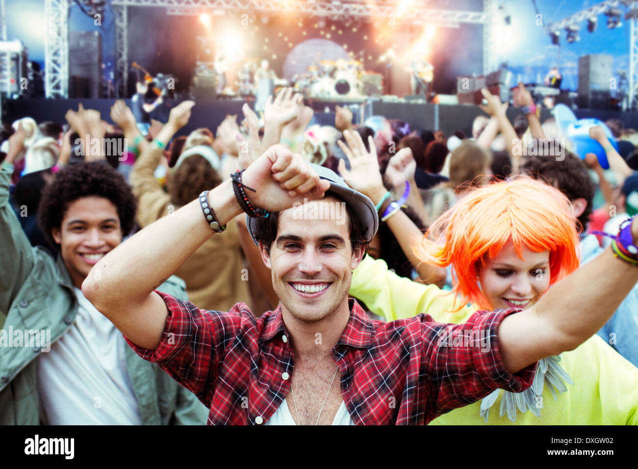Portrait of fans dancing and cheering at music festival Stock Photo