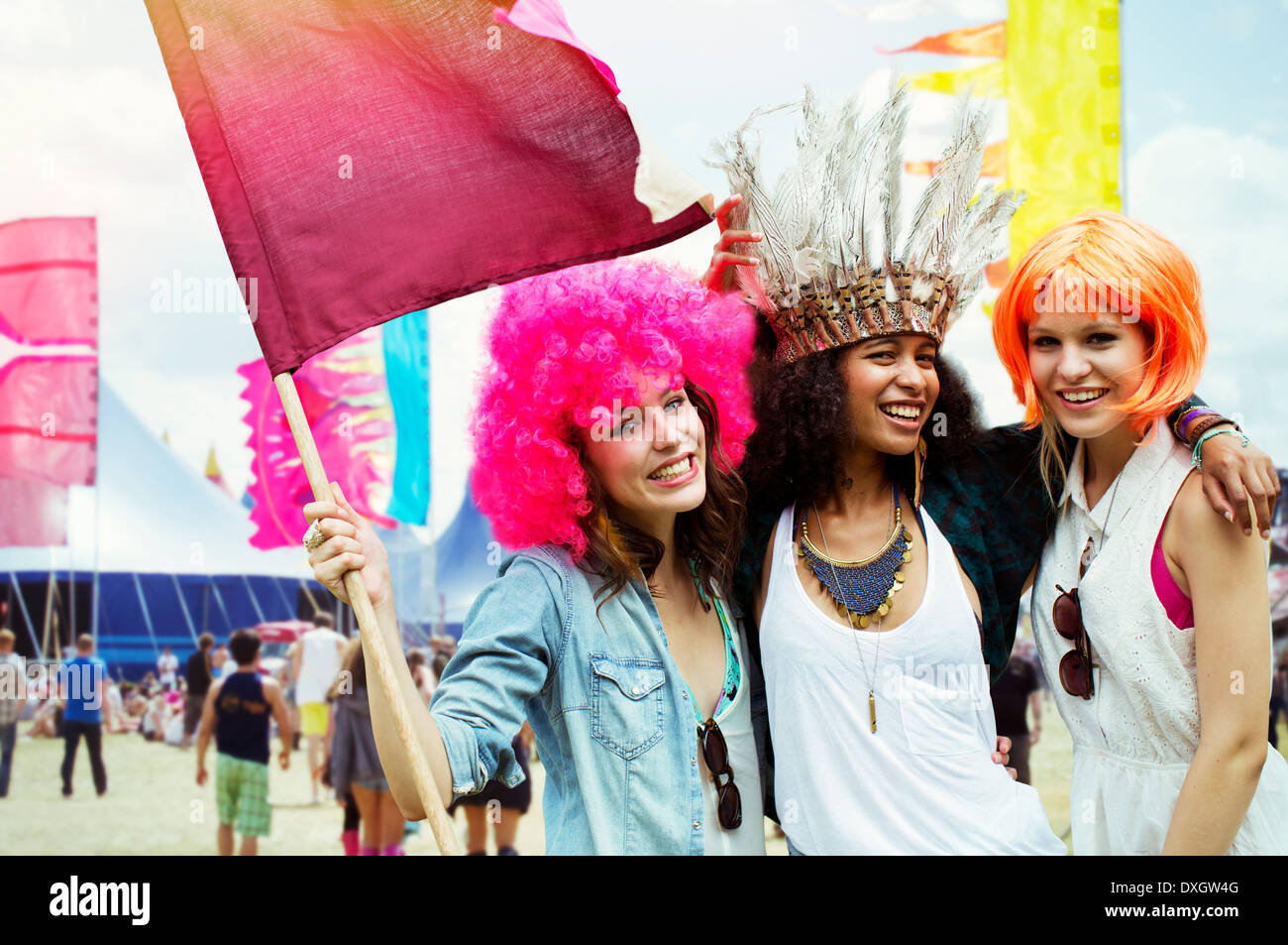 Portrait of friends in wigs at music festival Stock Photo