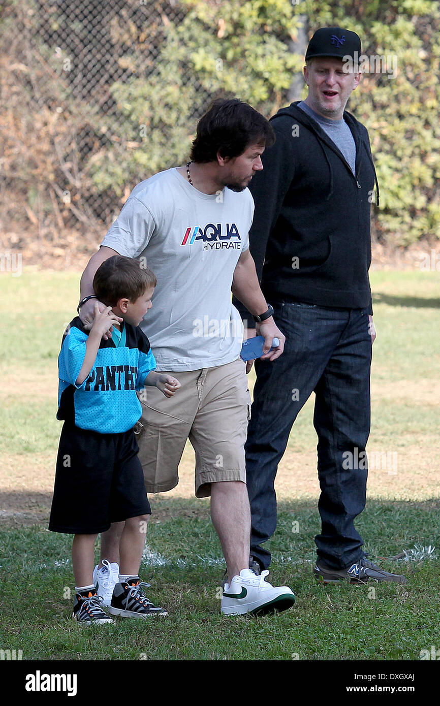 Mark Wahlberg with son Michael Wahlberg, as he bumps into Michael Rapaport on the field Mark