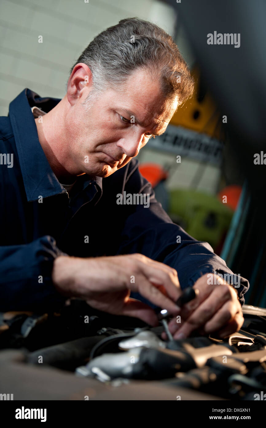Automobile mechanic working in garage Stock Photo