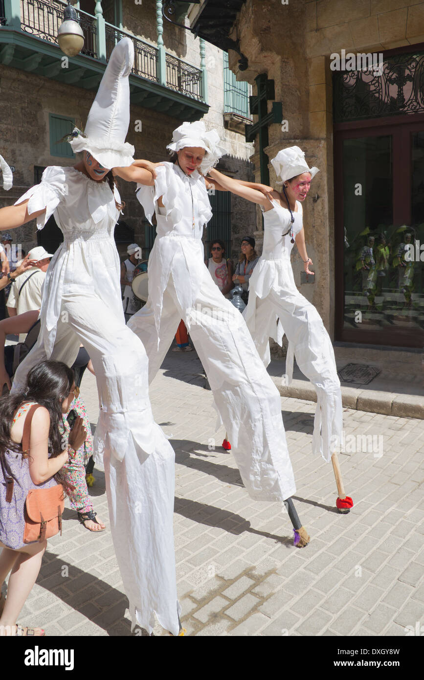 Three girls dancing on stilts in street Old Havana Cuba Stock Photo