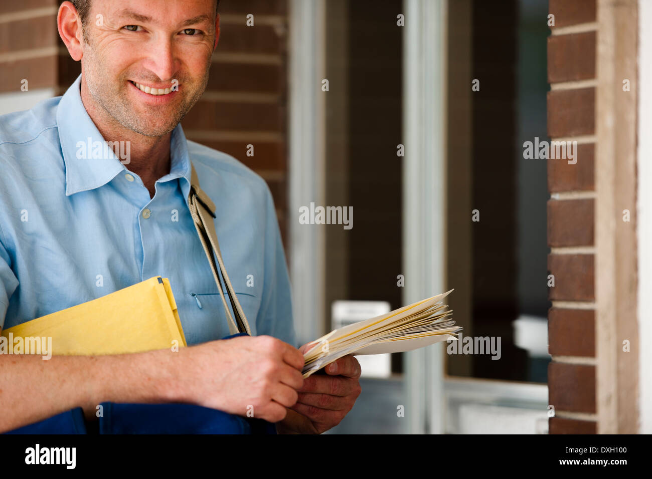 Mailman delivering mail Stock Photo Alamy