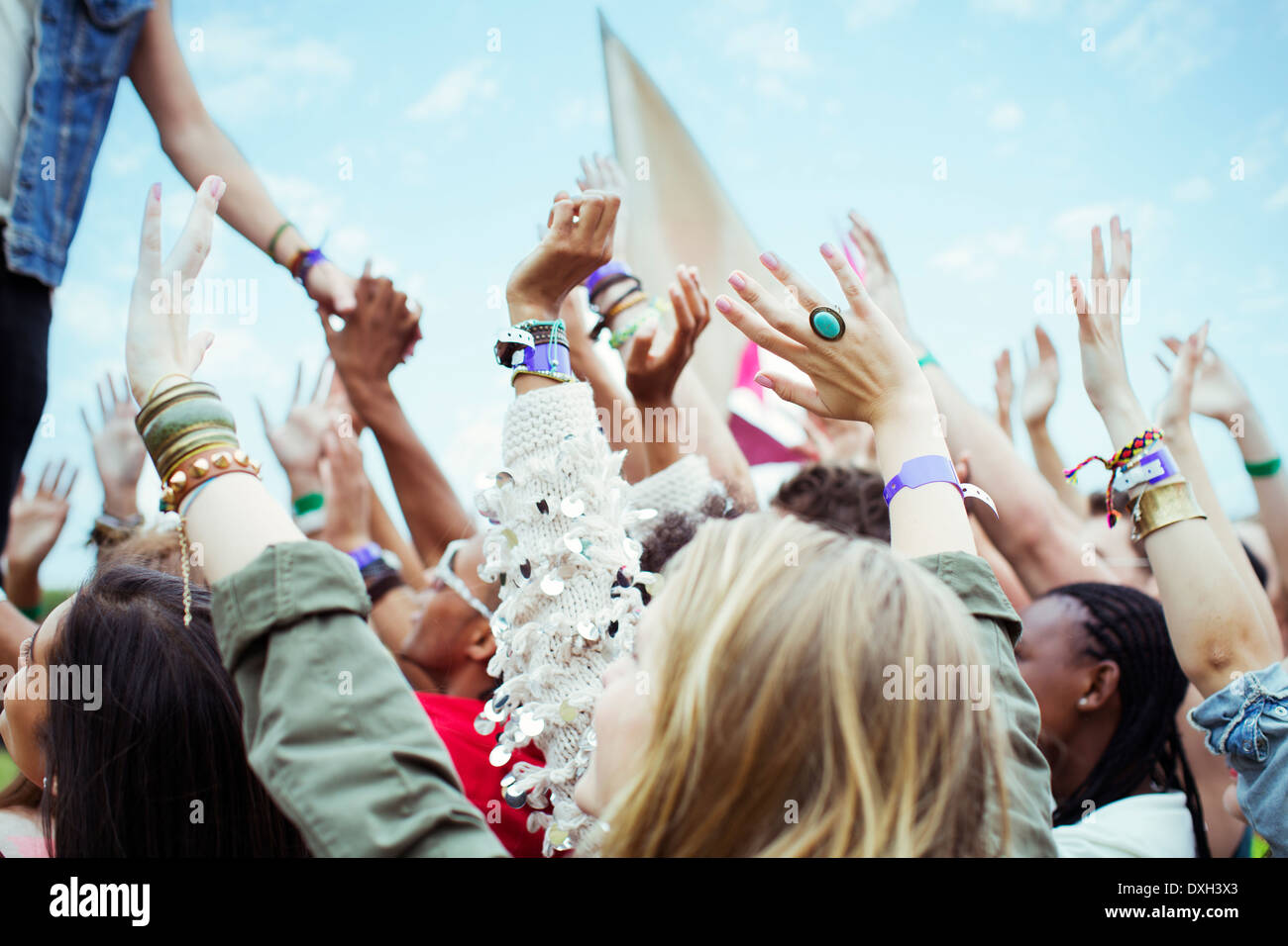 Fans reaching to shake hands with performer at music festival Stock Photo