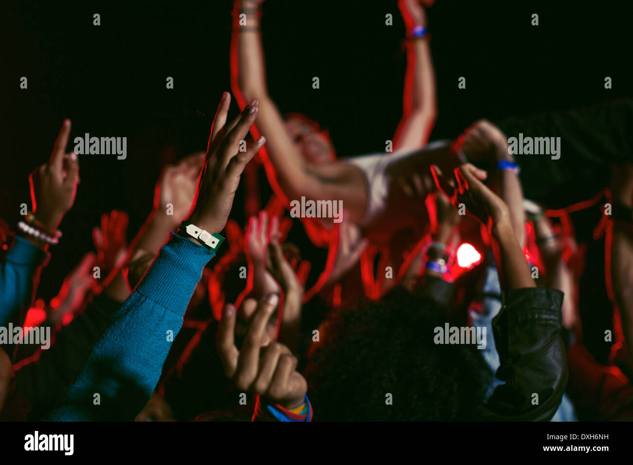 Man crowd surfing at music festival Stock Photo