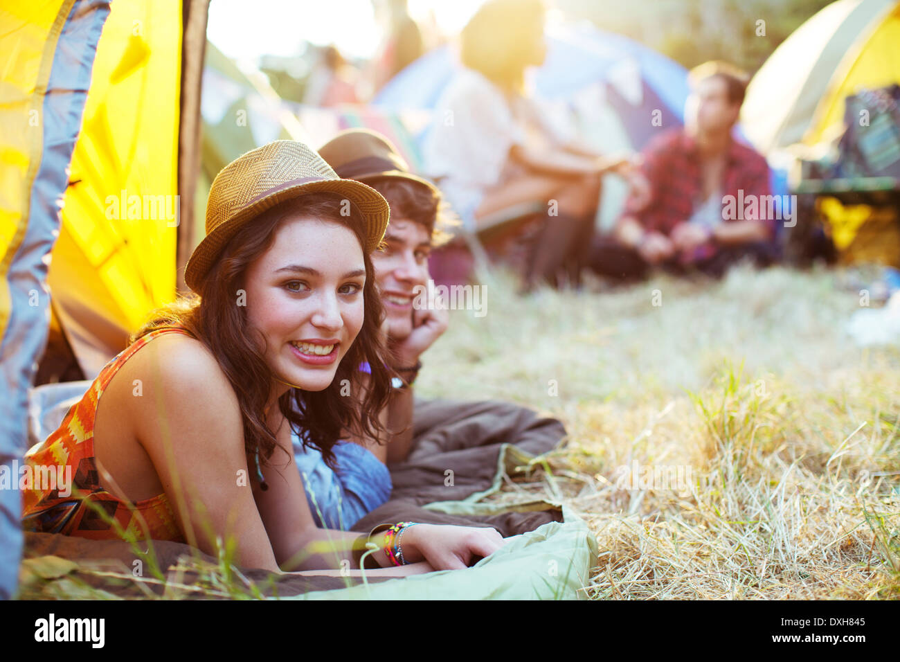 Portrait of couple laying in tent at music festival Stock Photo