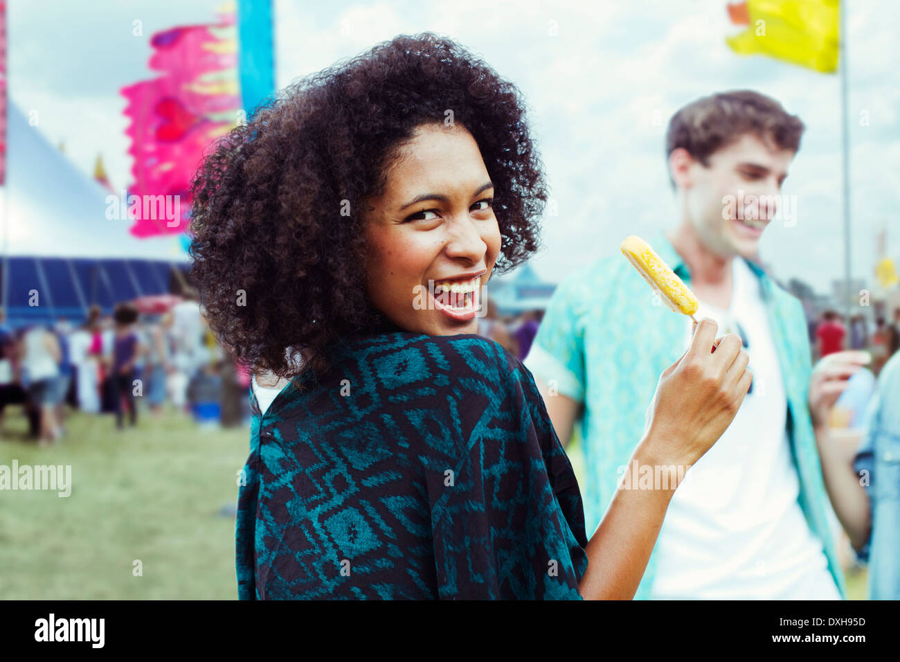 Portrait of woman eating flavored ice at music festival Stock Photo